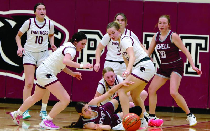 Timber Lake and Newell players scramble for possession of a loose ball during Timber Lake Lady Panther action vs the Newell Irrigators last Friday, Feb. 13. The Lady Panthers pulled out an exciting 41-48 win over the Irrigators. The Timber Lake girls are used to exciting finishes as nearly half of their games this season have been decided one way or the other by seven points or less. Topic Photo/Marie DuPreez