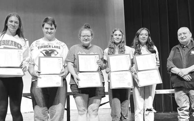 Receiving $1000 scholarships from CRST Telephone Authority were (l-r) Jasmine Nash, Riley Montgomery, Molly Miller, Natalie Lawrence, and Kessa Bigger. Ken White Eyes, right, presented the scholarships.