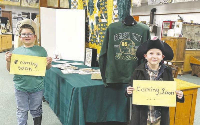 Blane and Brady Biegler and their mom, Kaleigh, are putting together a Tucker Kraft/Green Bay Packers exhibit at the Timber Lake Museum, which will be finished soon. Photo by Kathy Nelson