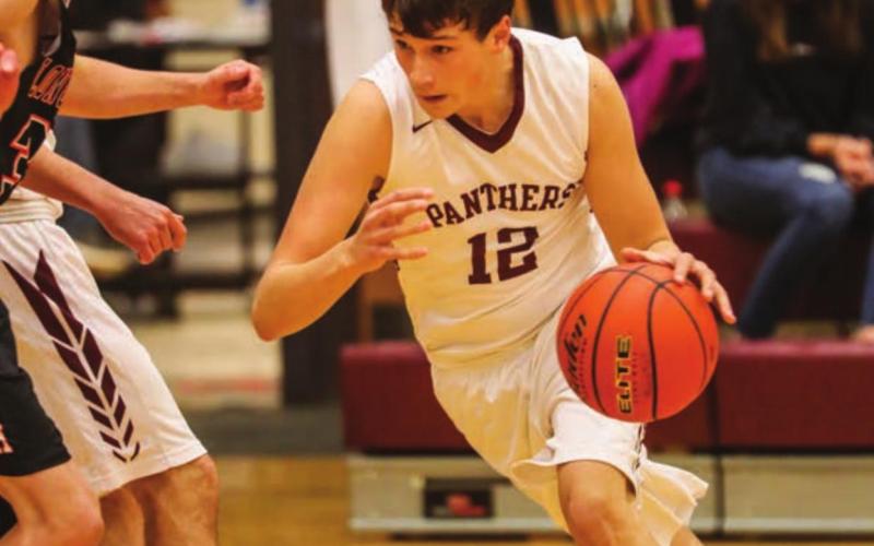 Timber Lake starter Dixon Booth dribbles to the hoop during a home contest versus Faith. Photos by Robert Slocum
