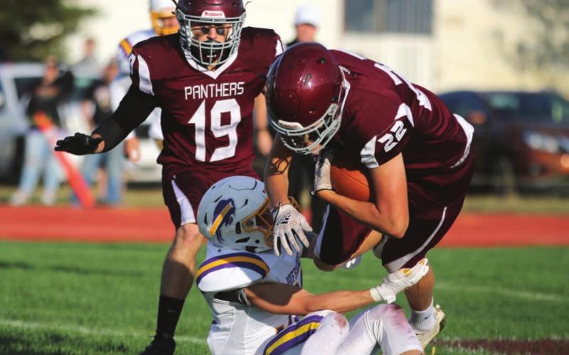 Running back Dixon Booth (22) bowls over a Stanley County defender during a run in the second quarter of Timber Lake’s 40-0 win in the 2021 football season opener last Friday. Looking on is Jayce Lawrence (19). Photos by Jon Flatland