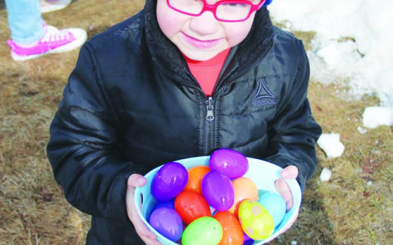 Ryker Bridges, son of Wesley and Pelagie Bridges, shows off the colorful collection of candy-filled Easter eggs he gathered Saturday morning, April 8, during the annual 4-H Easter Egg Hunt held at the Dewey County Courthouse in Timber Lake.