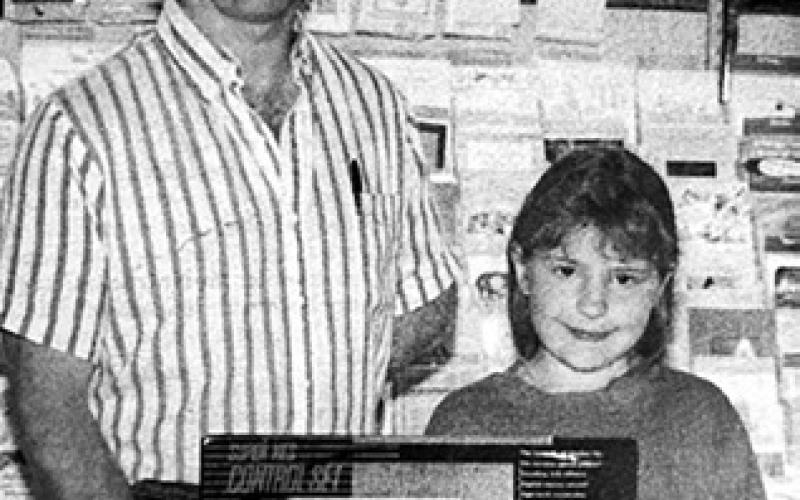 Samantha Reinbold, daughter of Robert and Jeanette Reinbold, was the winner of a Super Nintendo given away during the Kids’ Week promotion. Making the presentation is Dennis Holzer of Holzer’s Super Valu. Timber Lake Topic, June 17, 1993