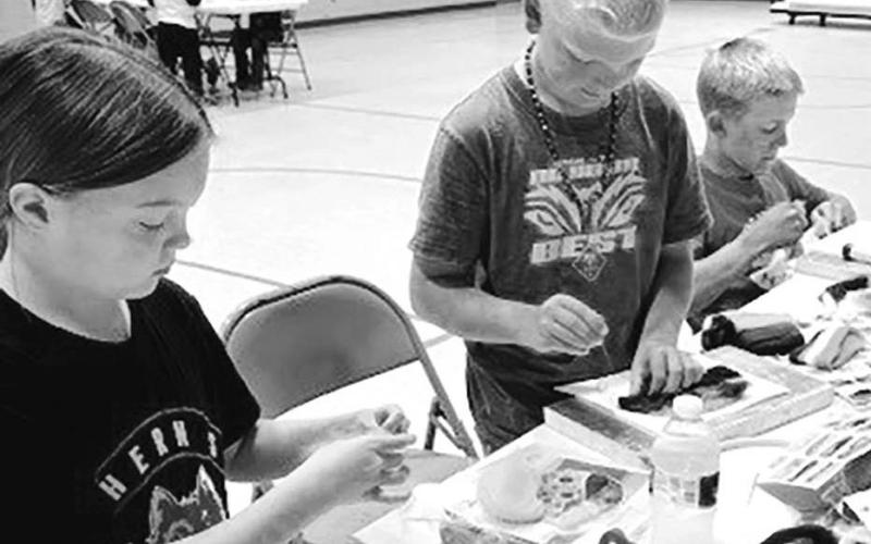 (L-R): Zoey Spiel, Eli Zeug and Isaac Zeug work patiently on their needle felting projects.