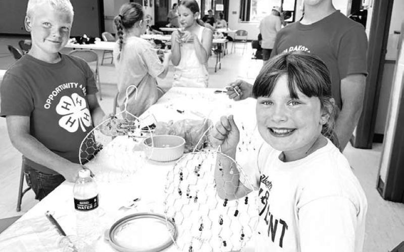 (L-R): Eli Zeug, Clara Nilson and Isaac Zeug made sun catchers.