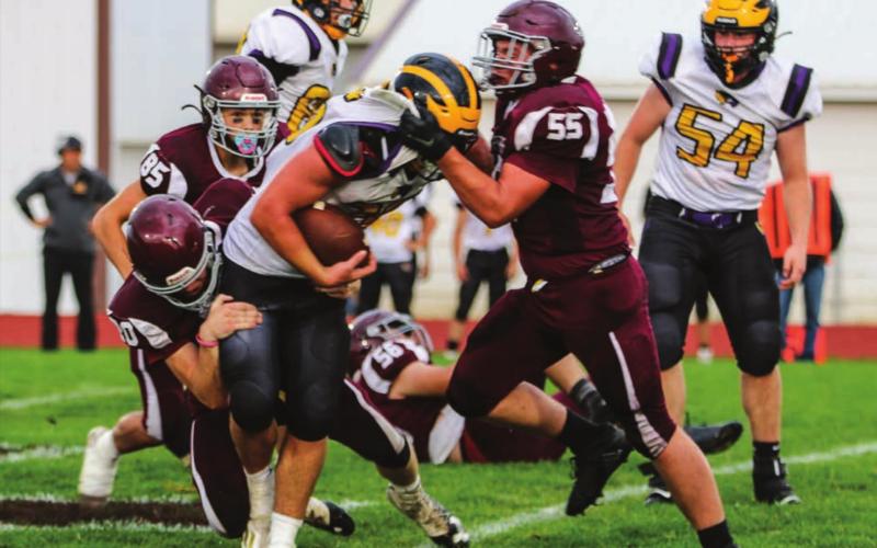 Panther defenders AJ Lindskov (55) and Thane Keller (20) team up to stop Wolverine runner Brenden Begeman during their contest in Timber Lake on Sept. 3. Photo by Jon Flatland