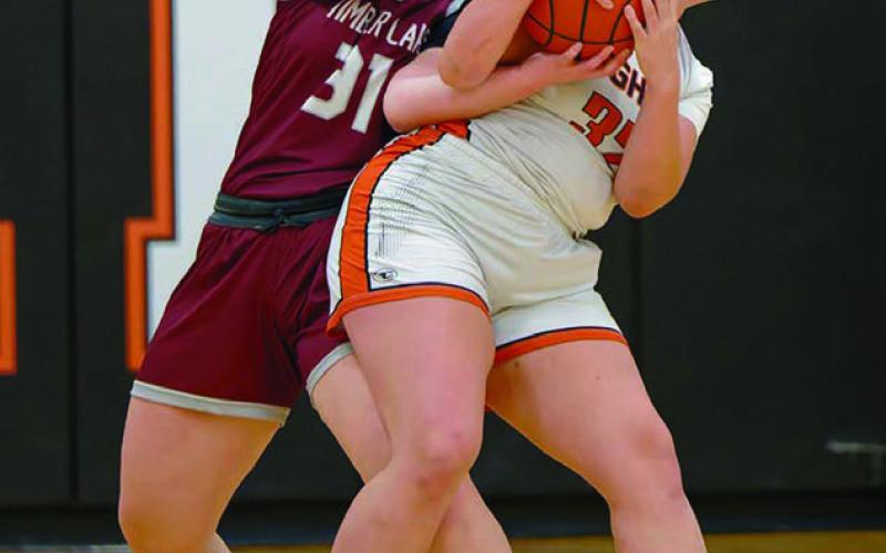 Kate Biegler (31) of Timber Lake wrestles for control of a rebound with Faith’s Shaie Veit in Faith last week. The Lady Panthers claimed their first win of the season with a thrilling 64-63 overtime victory. Biegler scored 12 points in the effort. Topic Photo by Marie DuPreez