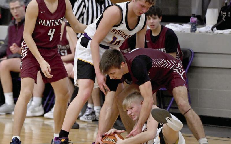 Timber Lake’s Gavin Farlee fights an unidentified Herreid-Selby player for control of a loose ball during the Panthers’ 58-29 win over the Wolverines last week. Looking on are Broc Bauer (4) and Herreid-Selby’s Jared Weisbeck (10). Photo by Marie DuPreez