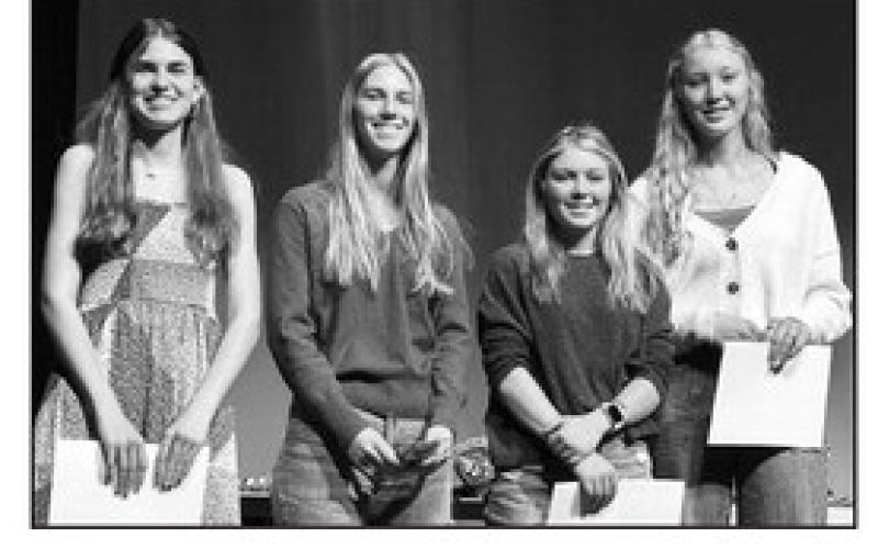 Junior Meredith Maciejewski (left) received a bronze award for her interactive bulletin board, and seniors (l-r): Averie Marshall, Kenlea Heck, and Kendyl Locken received honor cords to wear at graduation.