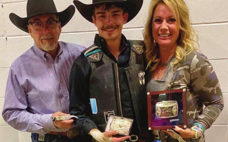 Bringin’ home the buckles Chance Schott of McLaughlin (ABOVE CENTER), pictured with his father, Dallas Schott, and Robin Blankenship, and Trey Young of Dupree (AT RIGHT) did well at the Badlands Circuit Finals rodeo in Minot Oct. 9-11.