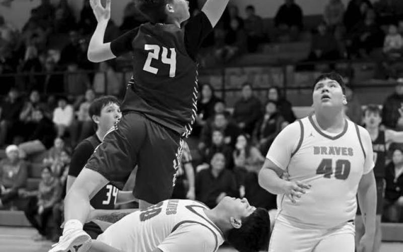 Timber Lake’s Kanton Hunt (24) drew a charging call after colliding with Cheyenne-EagleButte’s Danah Diver on a drive to the basket during inter-county boys basketball action in Eagle Butte last Tuesday, Feb. 18. Looking on for C-EB is Easton Lawrence (40) Photo by Marie DuPreez