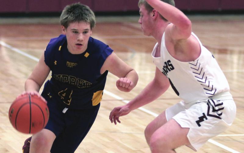 Dupree’s Roper Eaton (4) drives the ball up the floor as Timber Lake’s Treyton Du Preez defends during their recent varsity basketball contest. Photos by Jon Flatland