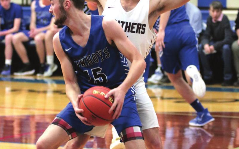 Timber Lake senior Jayce Lawrence defends Lemmon’s Sawyer Thompson (WITH BALL) in the post during their semifinal LMC conference matchup.