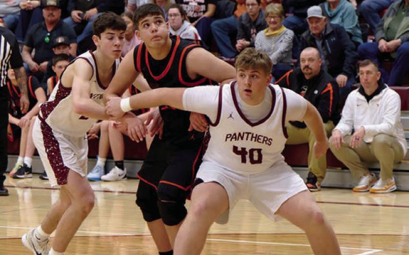 Left, Timber Lake’s Mason Bickel (40) boxes out a Faith defender as they eye a shot going up. Moving in for a potential rebound is Timber Lake’s Petet Maher. Topic Photo/Marie DuPreez