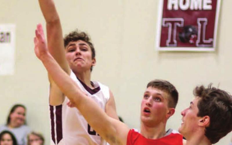 Panthers guard Kedrick Martin puts up a floater over Potter County’s Grant Luikens with TL’s Hunter Schrempp looking on. Photo by Jon Flatland