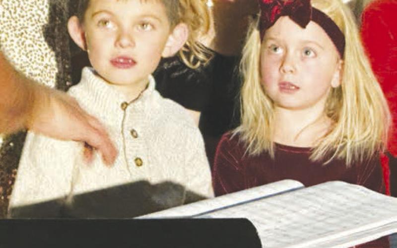Carefully watching Mr. Rose are Koleson Long and Josie Truax. Photos by Kathy Nelson