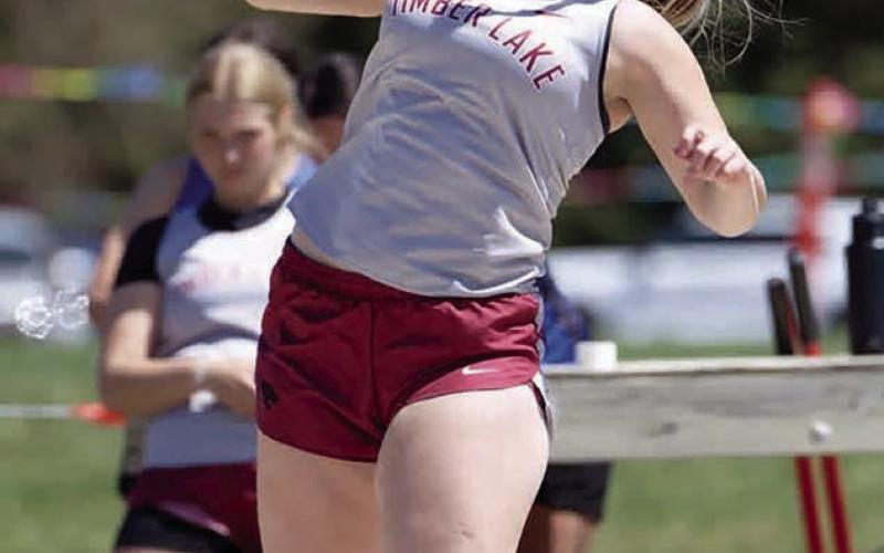 Katelyn Biegler reaches for power during the shot put competition at the Timber Lake Classic last week. She took top honors with a mark of 91 feet and 8 inches. Photo by Marie DuPreez