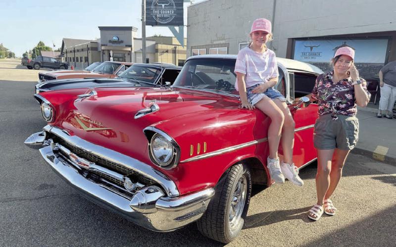 Marie Gross and her daughter, Sophia, were at the Rods n’ Reels event at The Corner Bar &amp;amp; Grill on Saturday, June 21, showing off their ride - beautiful 1957 Chevrolet with red and black interior. The vehicle is owned by their husband and father Richard Gross, who is one of the organizers of the event. Photos by Kathy Nelson
