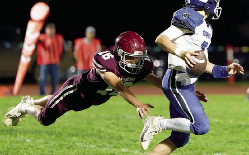 Sophomore Cooper Keller (16) makes a diving tackle on Lemmon-McIntosh quarterback Max Anderson during Timber Lake’s 46-28 Homecoming win over the Cowboys. The Panthers, 2-4 on the season, square off against 0-6 Gettysburg this Friday, Oct. 10. Photo by Marie DuPreez