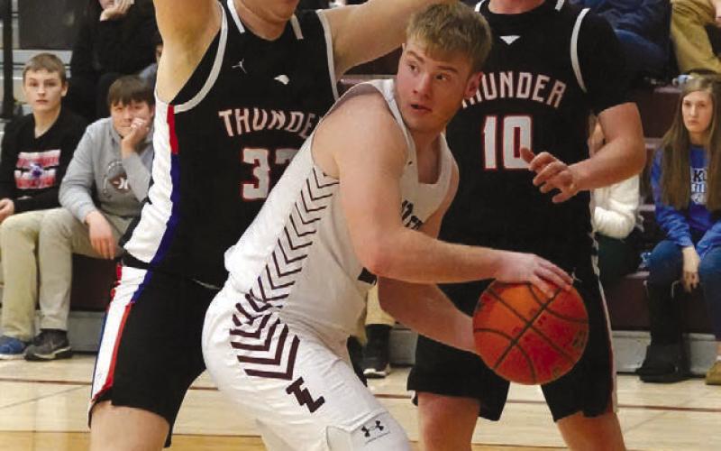Junior forward Treyton DuPreez looks for a teammate to pass to after getting trapped on the baseline during Timber Lake’s win over North Central last Thursday.