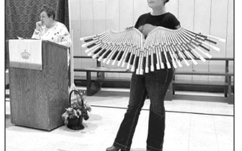 Kaycee Cronin displays a wall hanging created by Mitch Zeug from old piano keys that was auctioned off at the Prairie Parish Fall Festival held Sunday, Nov. 3, at the Isabel Community Center. Cronin is the new director of the Klein Ranch. Lois Bartlett, left, recorded the bids. Photos by Kathy Nelson