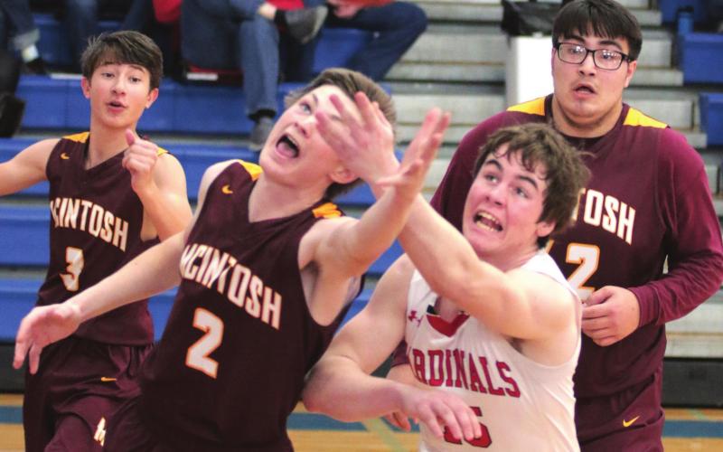 McIntosh’s Christian Campbell (2) and Bison’s Logan Reiff (25) during their conference tournament matchup. Watching are Tigers Wyatt Schell (3) and Daniel Demery (42). Photo by Jon Flatland