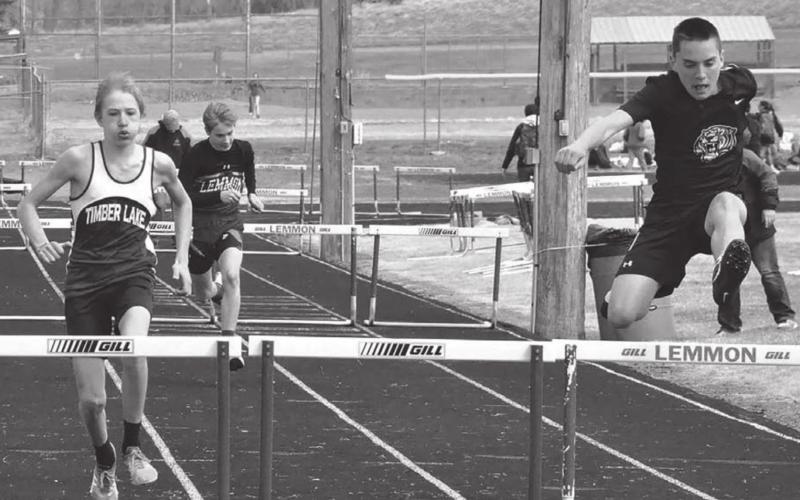 Timber Lake’s Isaac Assman (L) and Spencer Olsen track meet held April 11. (R) compete in the hurdles at the Bowman junior high Photos by Kathy Olson