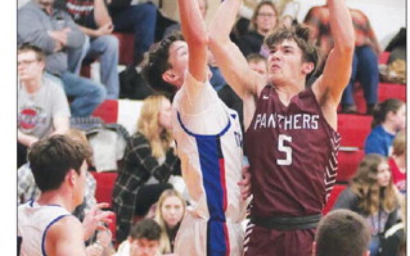 Panther guard Gavin Farlee (5) puts a jump shot up past the attempted block of a North Central defender during boys hoops action in Eureka last Thursday, Dec. 29. Farlee finished with six points in Timber Lake’s 57-54 overtime win. Photo by Jon Flatland