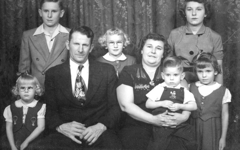 ABOVE: Valentine and Christine Keller and children. FRONT (l-r) Janet (Gill), Valentine, Christine (holding Ted), Karen (Keller); BACK: Duane (“Whitey”), Patricia (Horner) and Arlene (Holzer). NOT PICTURED: Terry, the youngest son.