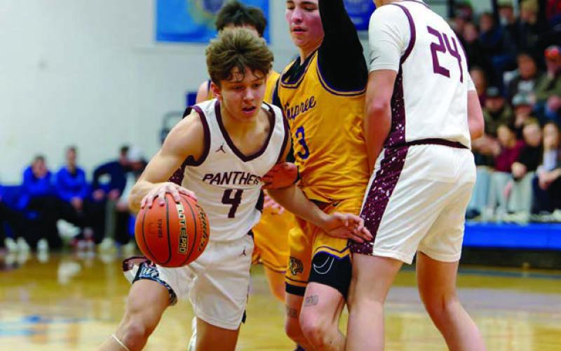 Broc Bauer (4) dribbles around a screen set by teammate Kanton Hunt (24) on Dupree’s Dayson Kennedy during the LMC Boys Basketball Tournament title game last Saturday. Topic Photo/Marie DuPreez