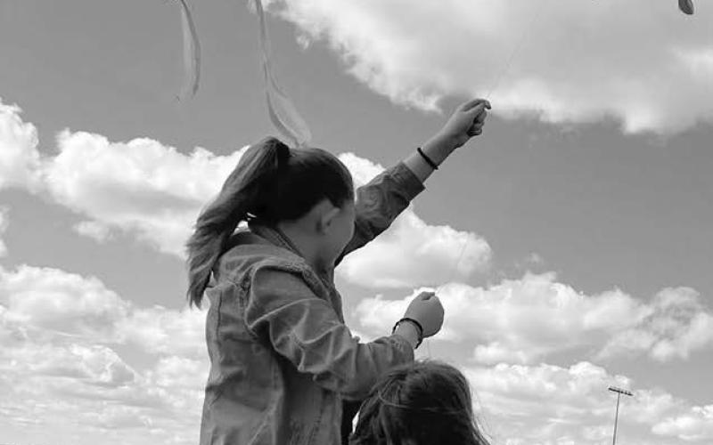 Go fly a kite ... Timber Lake Elementary School students took advantage of a warm sun and brisk breeze to fly kites at Doug Kraft Field last week.