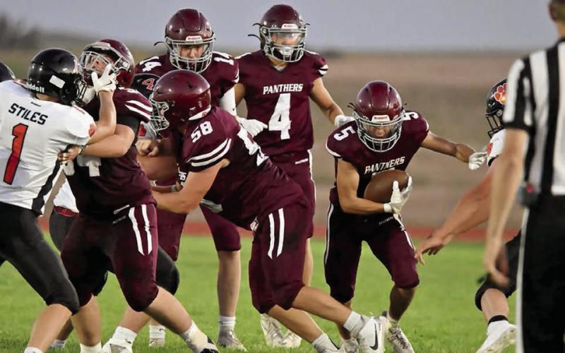 Rance Gross (5) shoots for a gap in the line during Timber Lake’s football season opener against Ipswich last Friday, Aug. 22. Creating a hole for the sophomore running back are Mason Bickel (54) and Xander Keller (58) while Broc Bauer (4) looks on. Gross finished with 11 yards on the night as the Tiger defense kept the Panthers in check. Photo by Marie Du Preez
