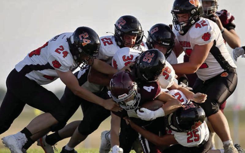 Panther sophomore Broc Bauer (4) is swarmed under by a half-dozen Ipswich Tiger defenders during Timber Lake’s loss in the season opener last Friday, Aug. 22. The Panthers have a bye week and will return to action against North Central next week. Photo by Marie Du Preez
