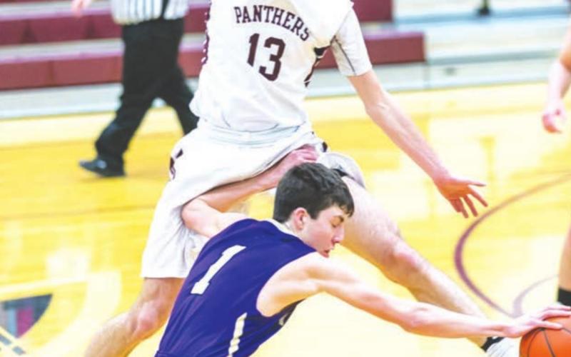 Kadoka Area’s Cole O’Bryan dribbles past a leaping Hunter Schrempp of Timber Lake during boys basketball action last Tuesday. The Panthers earned a 56-46 victory with Schrempp contributing 10 points and a handful of rebounds. Photo by Robert Slocum