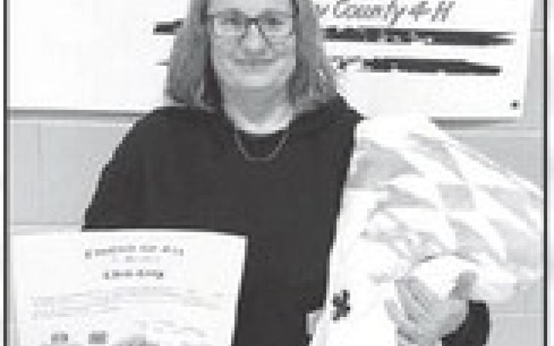 Chris Long, 2024 Friend of 4-H winner, was presented with a certificate and a blanket.