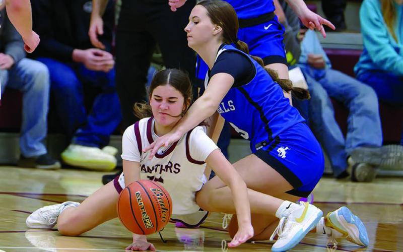 Kylie Lawrence (left) recoils from a forearm to the face while diving for a loose ball in Timber Lake’s loss to Lemmon in girls basketball action last Friday, Dec. 12. Timber Lake travels to New Underwood for a noon tip-off on Saturday, Dec. 20. Topic Photo/Marie DuPreez
