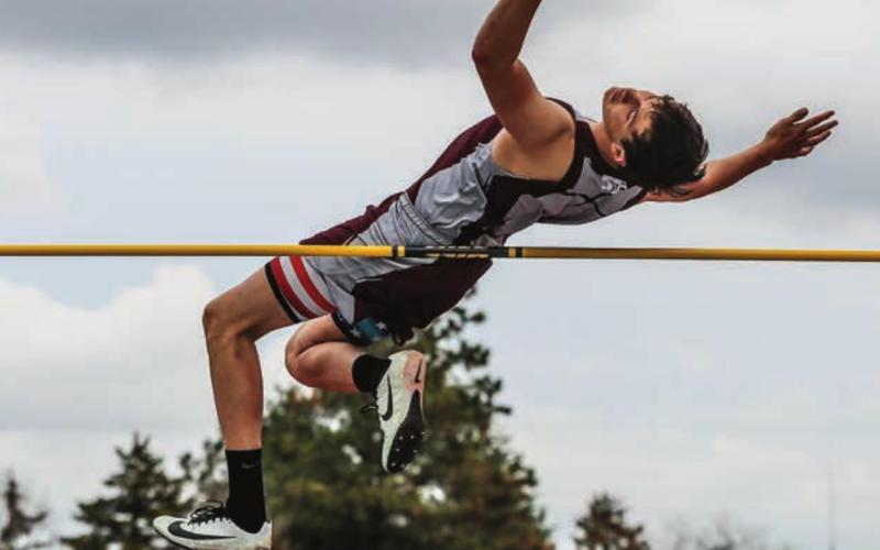 Dixon Booth launches himslf over the high jump barrier.