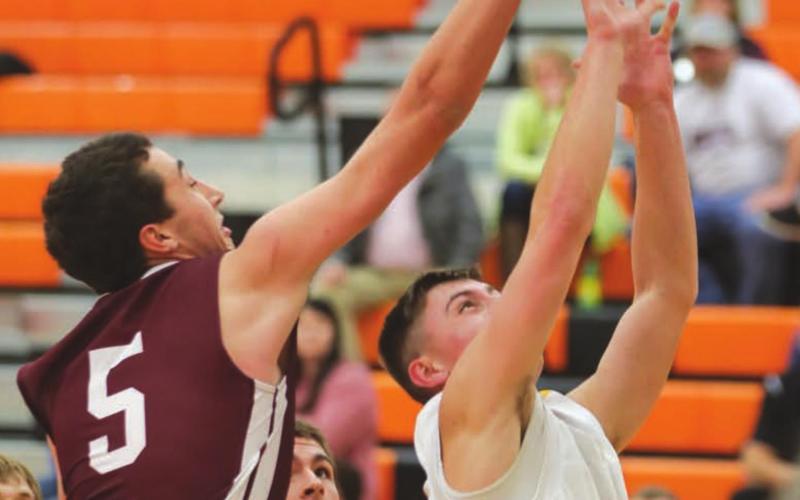 Timber Lake senior Trenton Hansen blocks the shot of an opposing player.