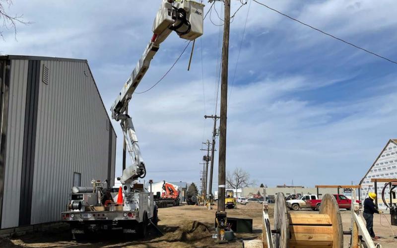 ABOVE: A Moreau-Grand crew gets ready to move a pole in the alley of Block 17 behind the post office.