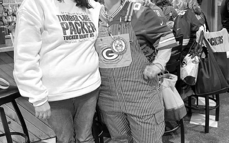Janna Bollinger (left) of The Corner investor team helped host the Monday night party. Her cousin, Bobbie Traversie of Eagle Butte, was decked out in Green Bay attire. Photos by Kathy Nelson