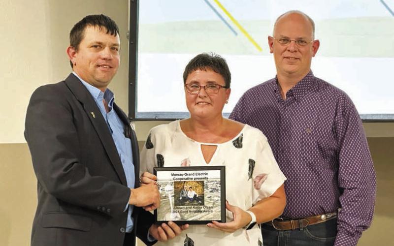 RIGHT: Kerry McLellan (District 5 director) presented the Good Neighbor award to Shawn and Kathy Olsen of Dupree.