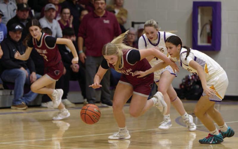 Timber Lake’s Maddy Hermes makes a steal and heads up-court while teammate Kylie Lawrence (left) fills a lane for a fast-break and Panther Head Coach Tuffy Thompson (maroon shirt) looks on. Topic Photo/Marie DuPreez
