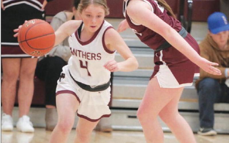 Timber Lake junior guard Kenlea Heck dribbles past McIntosh defender Josie Campbell to start a fast-break during first-round action of the Little Moreau Conference Girls’ Basketball Tournament. The top-seeded Lady Panthers were handed their first loss of the season in the semifinal round by Lemmon. Photo by Jon Flatland