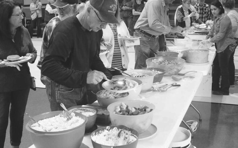 Tony Reinbold makes his selections at the salad table. Over 200 people were served at the supper.