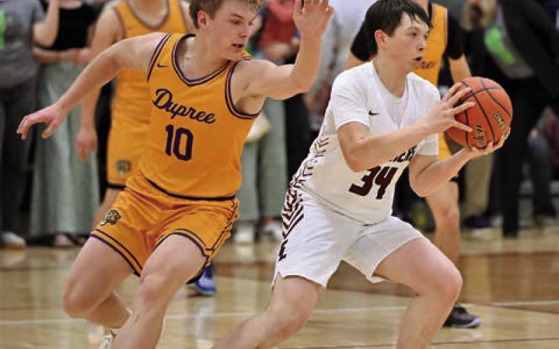 ABOVE: Rance Martin (34) steals the ball from Brayden Terveen-Smith during Timber Lake’s matchup against Dupree last Tuesday. Timber Lake overcame a 16 point first quarter deficit to pull out an exciting 54-52 victory over the Tigers.