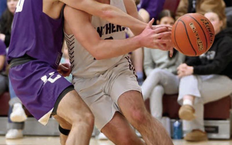 RIGHT: Treyden Beer is fouled by an unidentified Harding County defender while driving the baseline during Timber Lake's 58-35 win over the Ranchers last week. Beer finished the contest with a game-high 20 point performance to lead the Panthers.