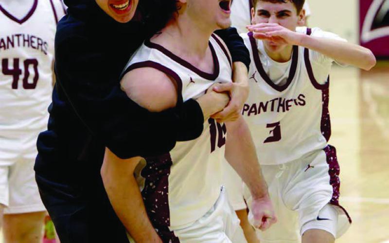 Treyden Beer (10, middle) gets mobbed by his teammates after draining a 15-foot buzzer-beater to give Timber Lake a 52-50 win over North Central on Saturday, Jan. 31. Included in the celebration were Mason Bickel (40), Braden Lawrence (3), and Jackson Bigger (in black). Topic Photo/Marie DuPreez