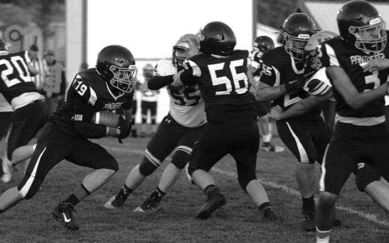 Timber Lake running back Jayce Lawrence (19) runs for daylight while the stellar TLHS offensive line blocks for him during a home game earlier this season. Photos by Jon Flatland