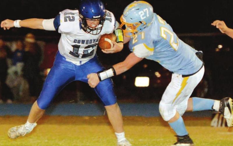 Lemmon/McIntosh senior QB Cody Thompson is pressured by Hamlin’s Michael Stevenson during their state semifinal round game. Photo by Roger Merriam, Watertown Public Opinion