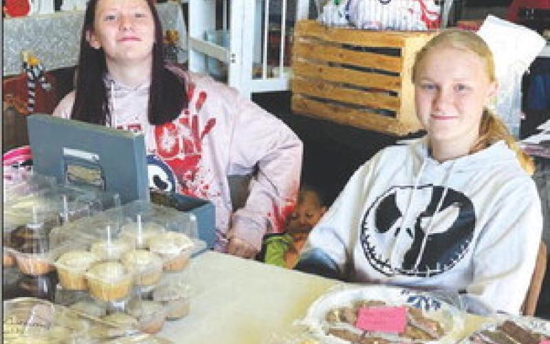 ABOVE: At the Trail City Fall Festival on Sunday, October 6, Kelly’s Donuts were back. When Kelly Landis passed away, his mother Rachel (left) gave his recipe and donut machine to the Trail City Hall so the tradition could continue. Karen (wearing Kelly’s favorite apron) and Carl Salzer tried their skills frying up dozens of donuts. RIGHT: Tristan Swift and Evelyn Gill sold baked goods to raise money for a middle school trip to Washington, DC next summer. Photos by Kathy Nelson